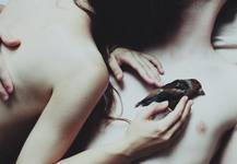 sad story about a girl who had to bring out the heart from the body of a sick boy. it now lies quietly in her hands and she rocks it to sleep.